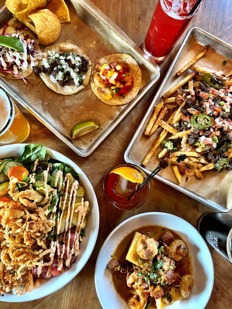 Overhead look at four delicious dishes and four beverages from Rapp's Barren Brewing Company.